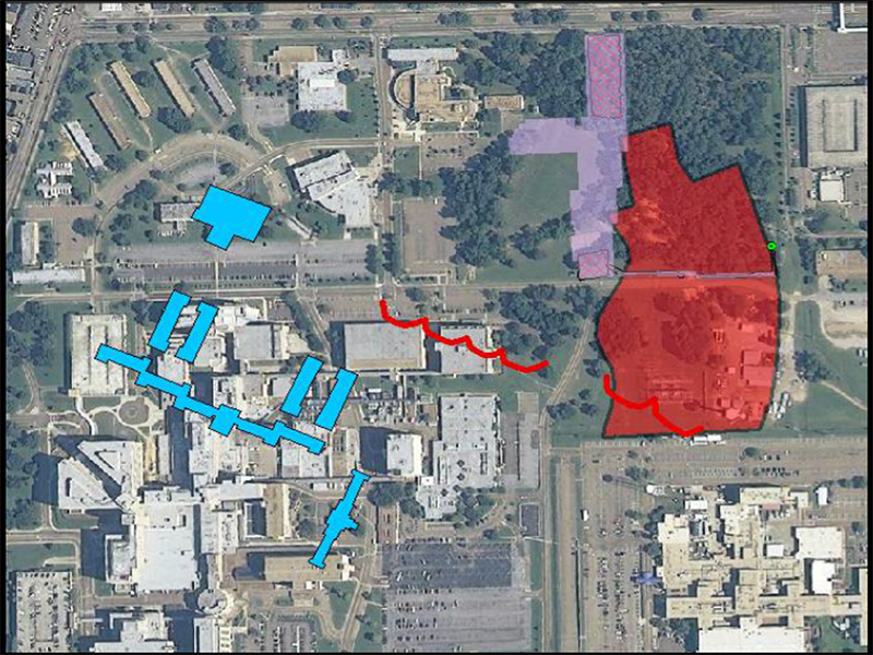 Modern aerial view of UMMC with historic overlay of Asylum main buildings (blue) and cemetery boundary (red)